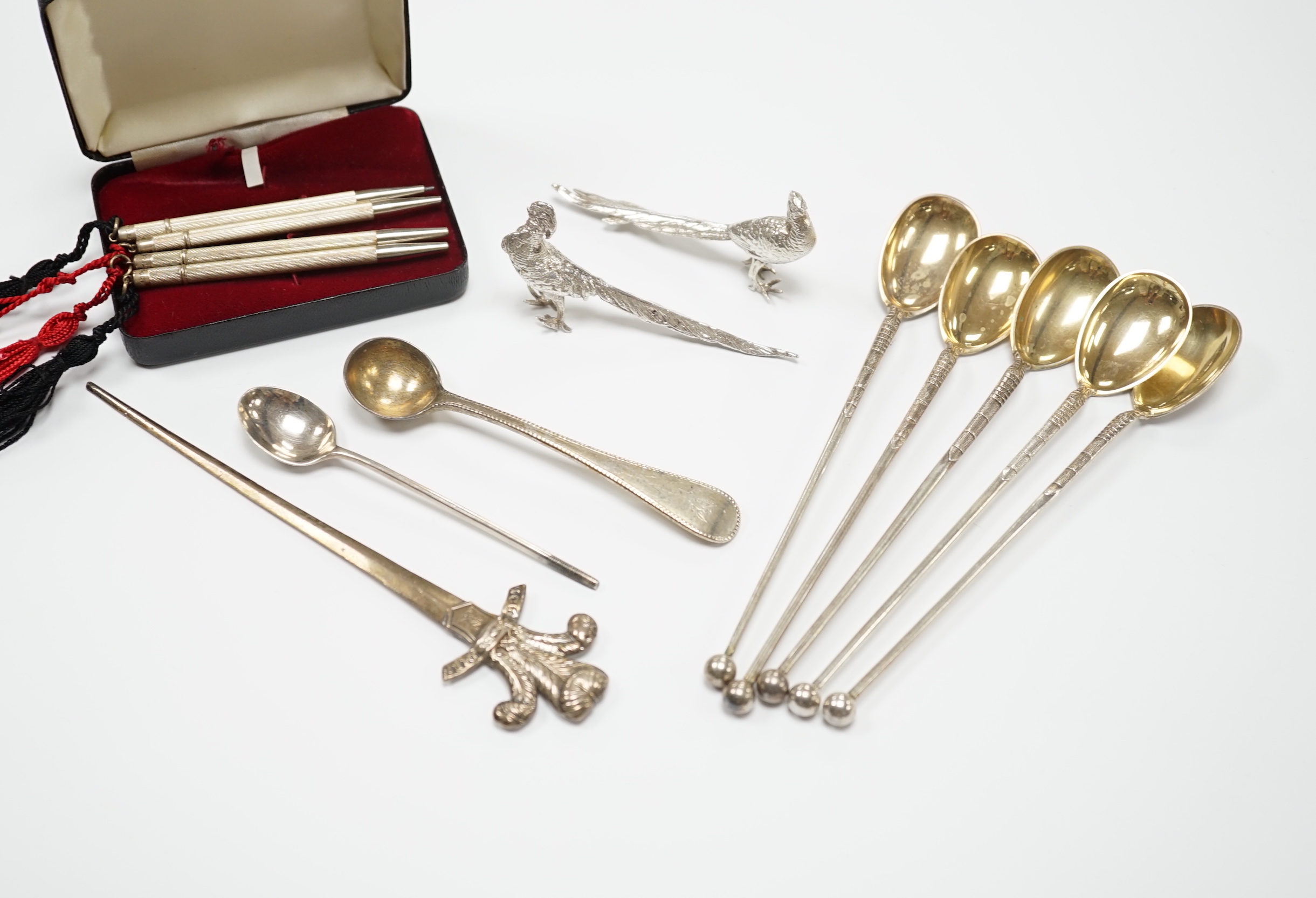 A pair of 1960's silver free-standing miniature model pheasants, 80mm, a set of four sterling mounted pencils, two small silver spoons, five Swedish white metal spoons and a Victorian letter opener, with the Prince of Wa